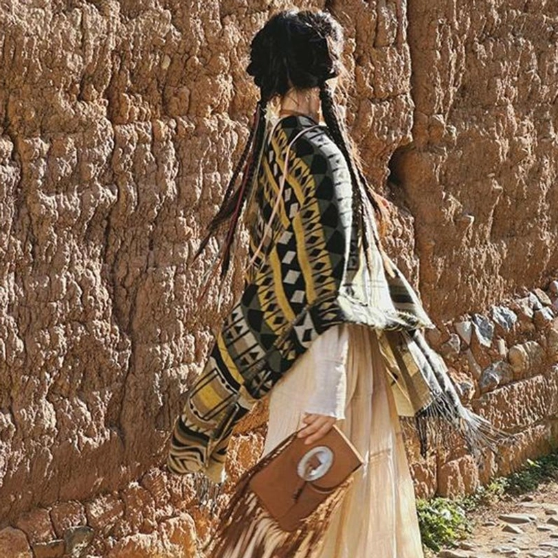 Tibetan geometric tassel shawl close-up texture detail, showing fine knitting craftsmanship and hand-finished fringe trim