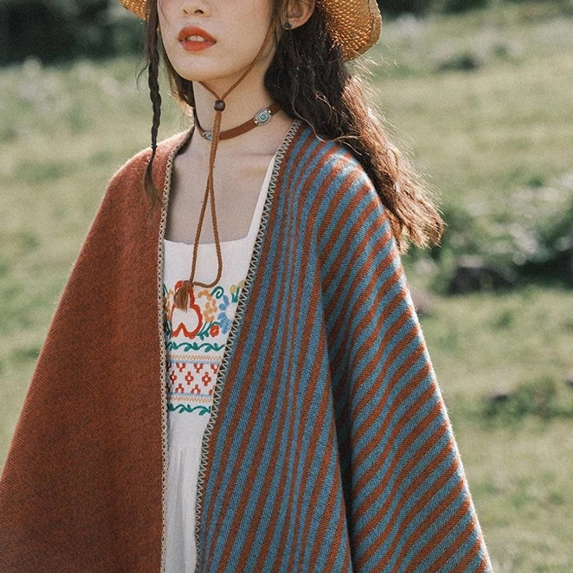 Tibetan ethnic shawl two-tone design with half stripe half solid rust color, paired with embroidered ethnic dress in outdoor field