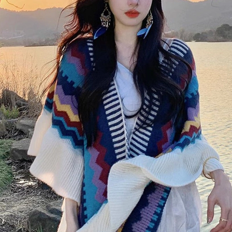 Model wearing Tibetan striped knit shawl at sunset lakeside, bohemian pattern with ruffled openings paired with white dress