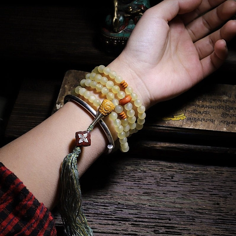 Tibetan sheep horn mala prayer beads worn as spiritual practice and mindfulness meditation tool
