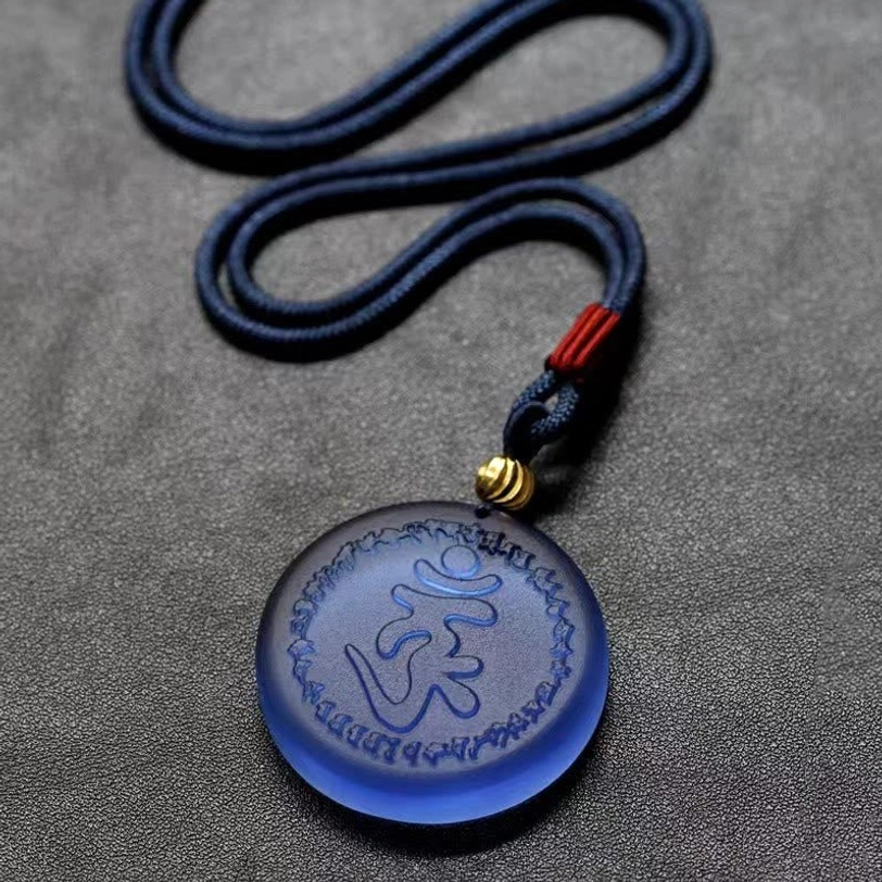 Tibetan Shurangama Mantra necklace flat lay showing full coiled navy rope cord and detailed pendant design with engraved mantra characters