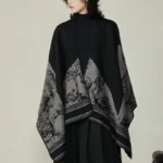 Tibetan sika deer forest reversible shawl wrap in black and gray, front view on model
