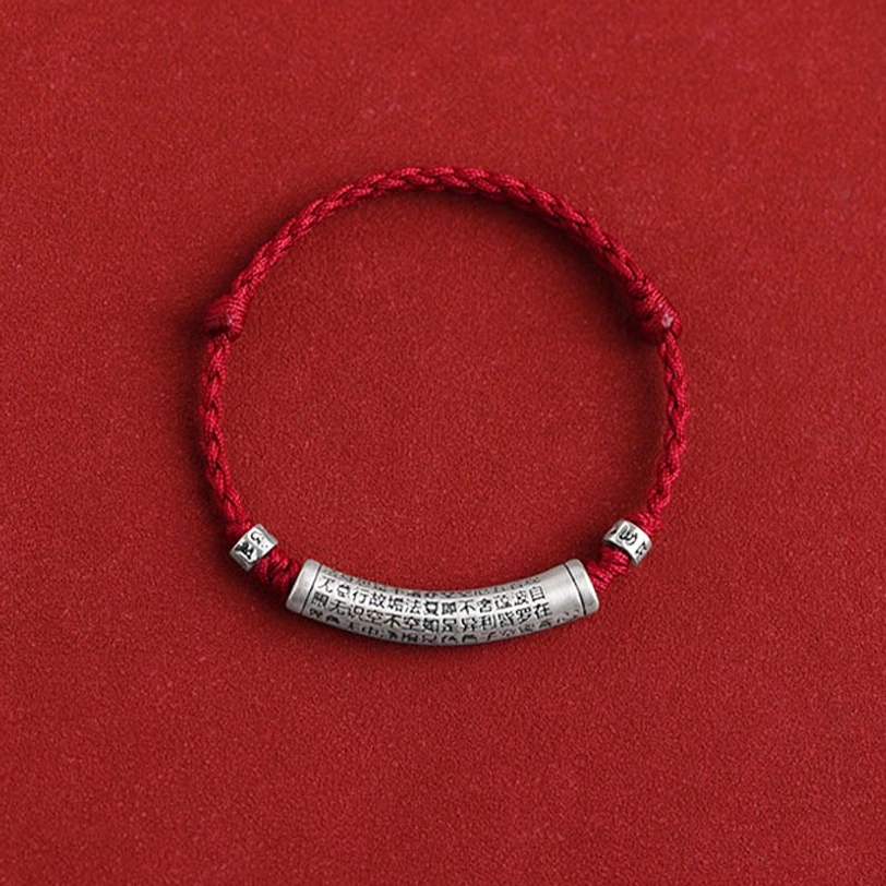 Handmade tibetan silver mantra bracelet showing intricate braiding and laser-engraved Buddhist text on pendant