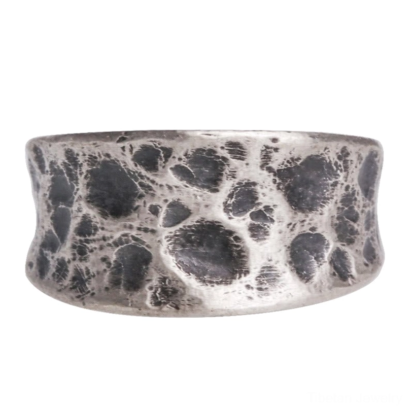 Handmade sterling silver protection ring full surface texture details plain background