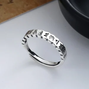 Tibetan mantra ring sterling silver adjustable sizing, scalloped band edges, clear Sanskrit engravings on polished silver surface