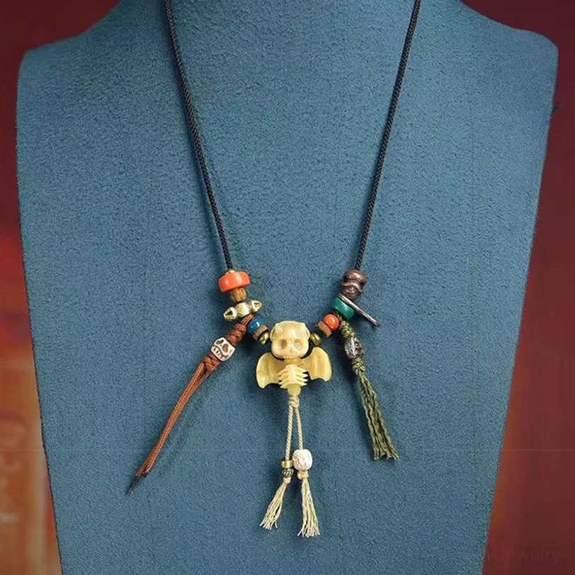 Tibetan skull Lord of Corpse Forest necklace product lifestyle shot - showing spiritual bone pendant with natural cord and agate accents