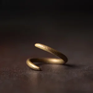 Tibetan spiral copper adjustable ring side view close-up showing antique bronze twisted open band design