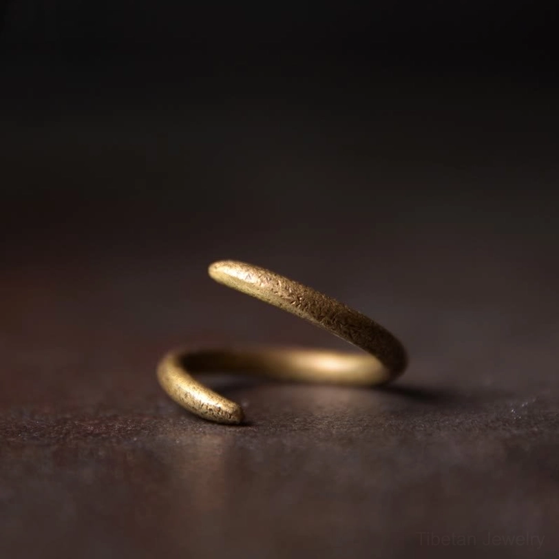 Tibetan spiral copper adjustable ring side view close-up showing antique bronze twisted open band design
