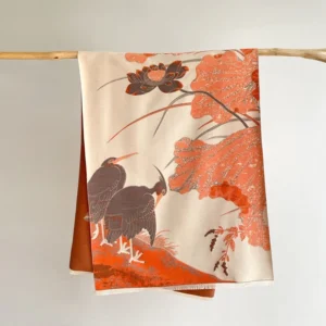 Tibetan printed shawl with crane and lotus design hanging display, featuring traditional Buddhist symbolism pattern