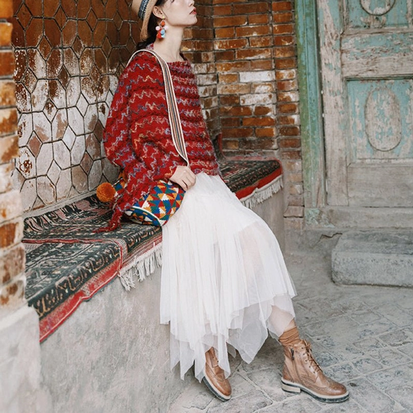 Tibetan striped poncho shawl with colorful horizontal stripes and tassel hem close-up view