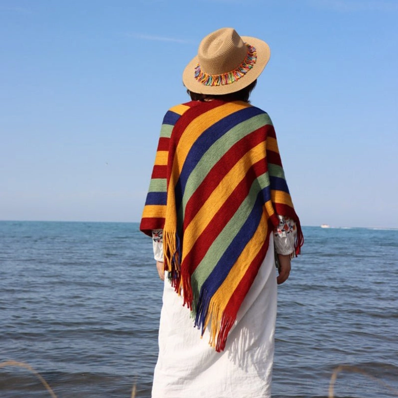 Tibetan striped poncho shawl draped styling showing versatile wrap wearing method and tassel details