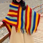 Tibetan striped poncho shawl with red yellow green vertical stripes worn on highland plateau outdoor setting