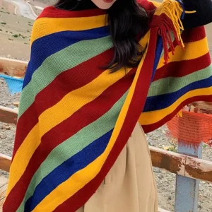 Tibetan tassel shawl worn at left side angle showing knit texture and shoulder fringe details on plateau