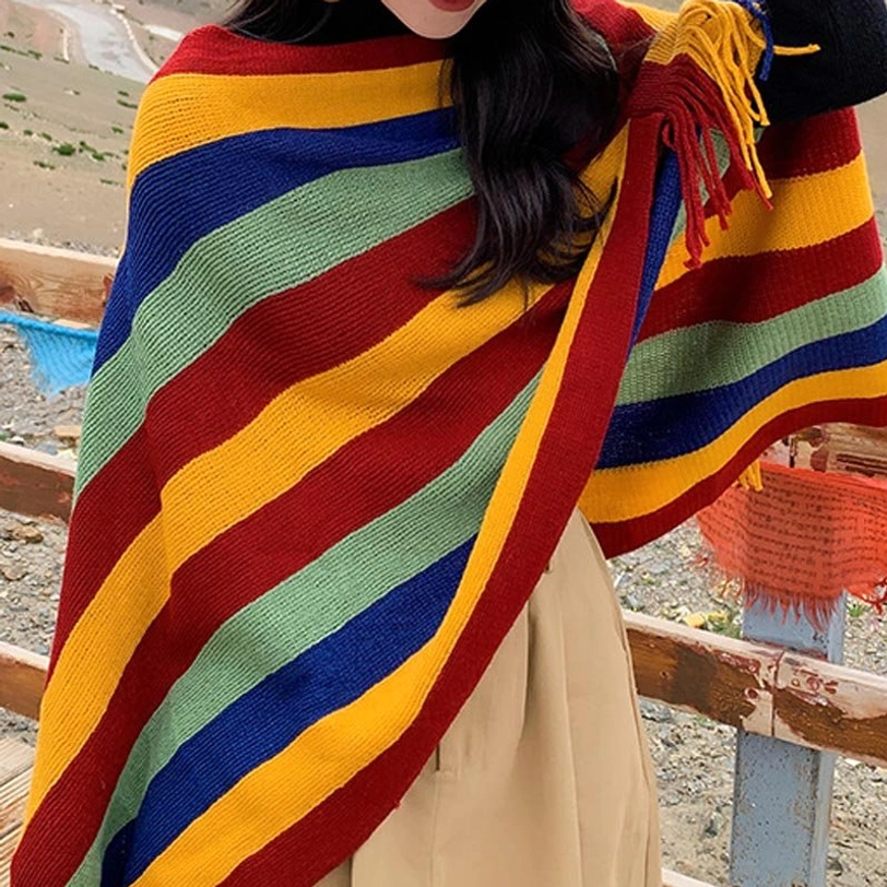Tibetan tassel shawl worn at left side angle showing knit texture and shoulder fringe details on plateau