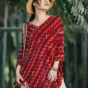 Multicolor striped V-neck tibetan shawl with soft knit texture styled outdoors with straw hat on green leaf background