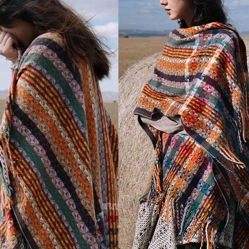 Outdoor lifestyle shot of Tibetan striped tassel shawl in natural grassland setting displaying bohemian aesthetic
