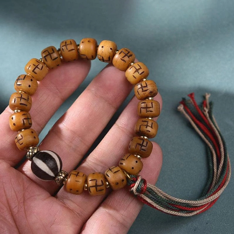 Tibetan camel bone bracelet with carved swastika beads and spiritual charm - meditation and protection wearable art