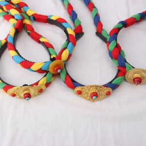 Tibetan colorful tassel hair clip with multicolor woven braids and copper decorative buckle - flat lay view