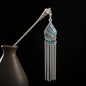 Tibetan water drop lily tassel hairpin left profile view with blue enamel pendant and silver chain tassels