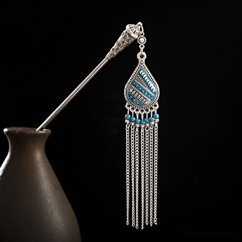 Tibetan water drop lily tassel hairpin left profile view with blue enamel pendant and silver chain tassels