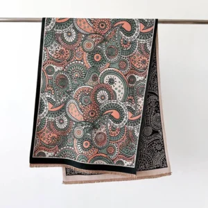 Tibetan ethnic tassel shawl flat lay hanging on metal rod, displaying double-sided reversible paisley print and fringed bottom edge on white background
