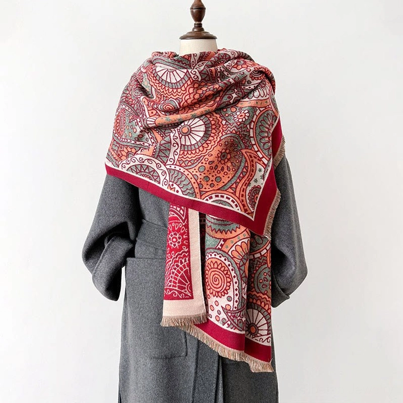 Tibetan tassel shawl product display showing reversible paisley design, multi-tone border, and hand-woven fringe detail on neutral background