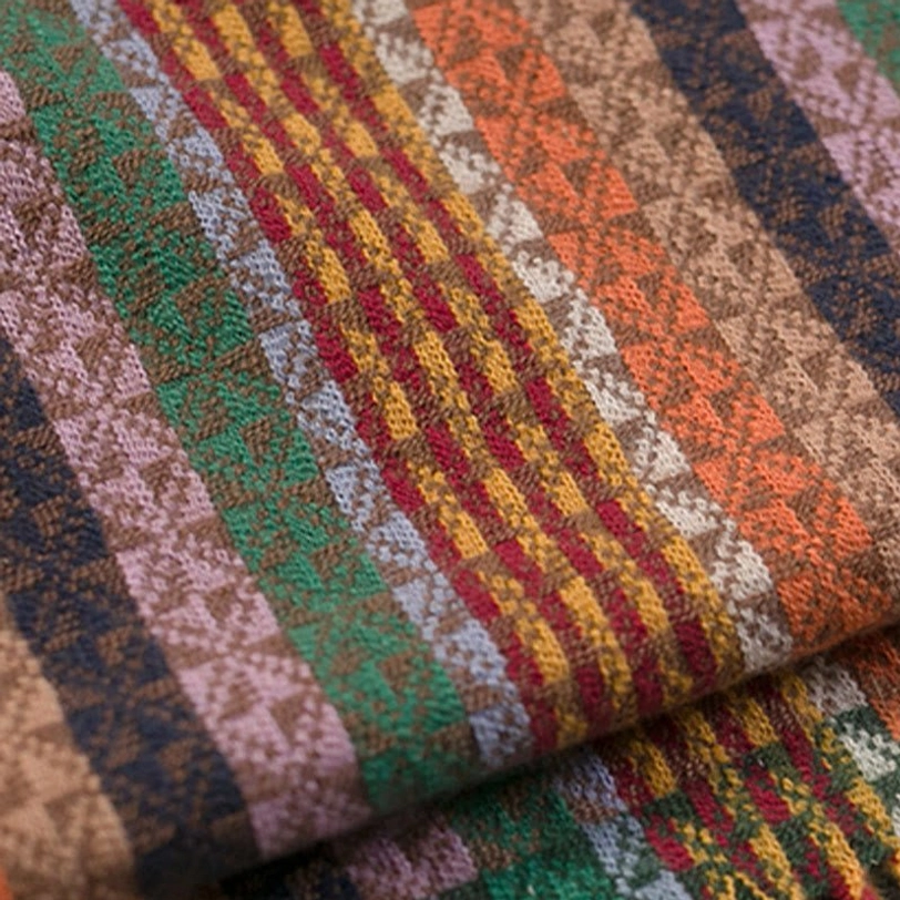 Tibetan tassel shawl styled with layered clothing showing versatile wardrobe integration and cozy comfort