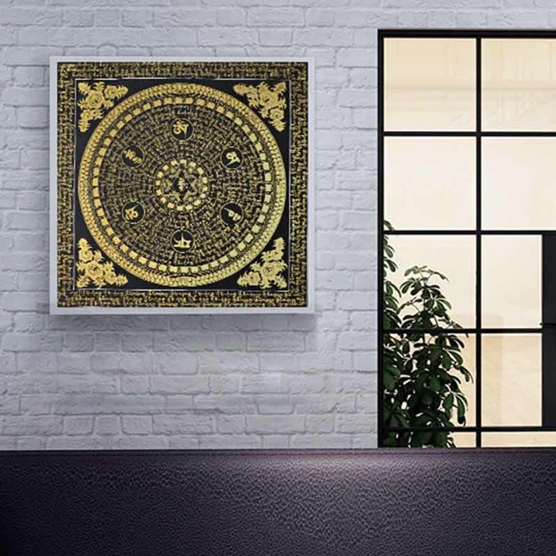 Black-gold Tibetan Om Mani Padme Hum mantra thangka framed artwork displayed as minimalist living room wall decoration