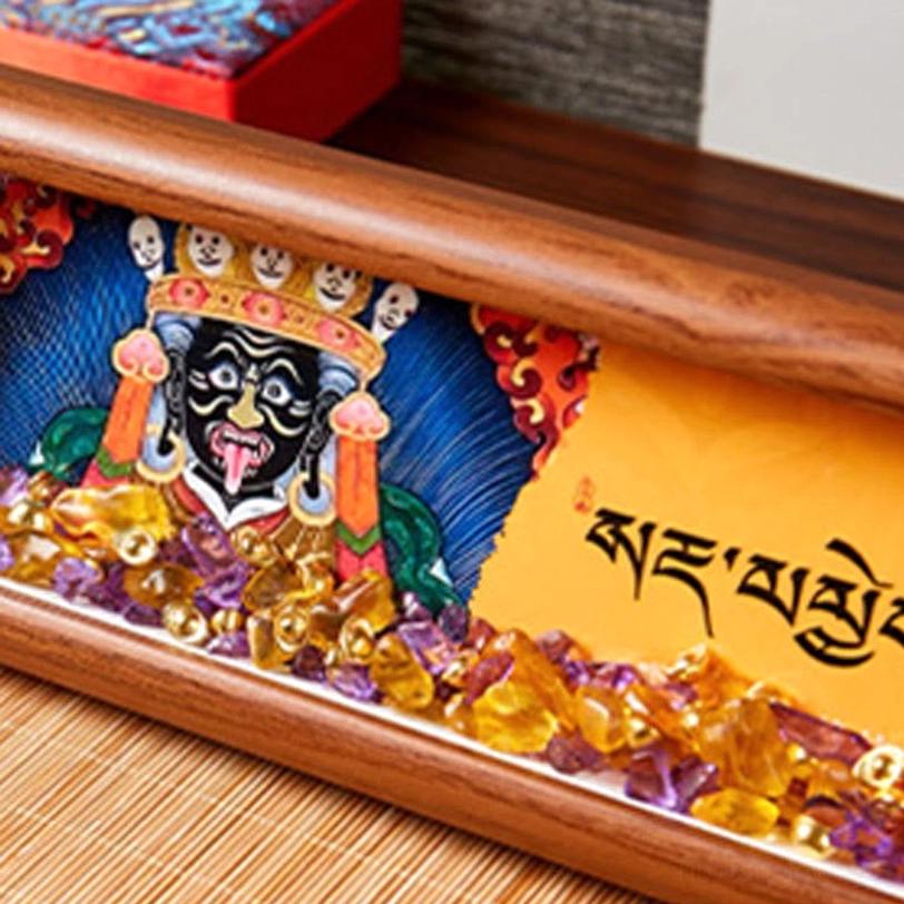 Close-up detail of Buddha deity thangka painting with ornate crown and blue-red decorative background surrounded by purple crystal inlays
