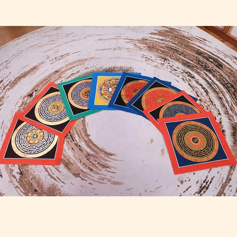 Multiple Tibetan thangka paintings arranged in fan display, showcasing variety of color borders and mandala designs