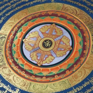 Close-up detail of handmade tibetan thangka mandala with gold vajra cross and colorful lotus borders