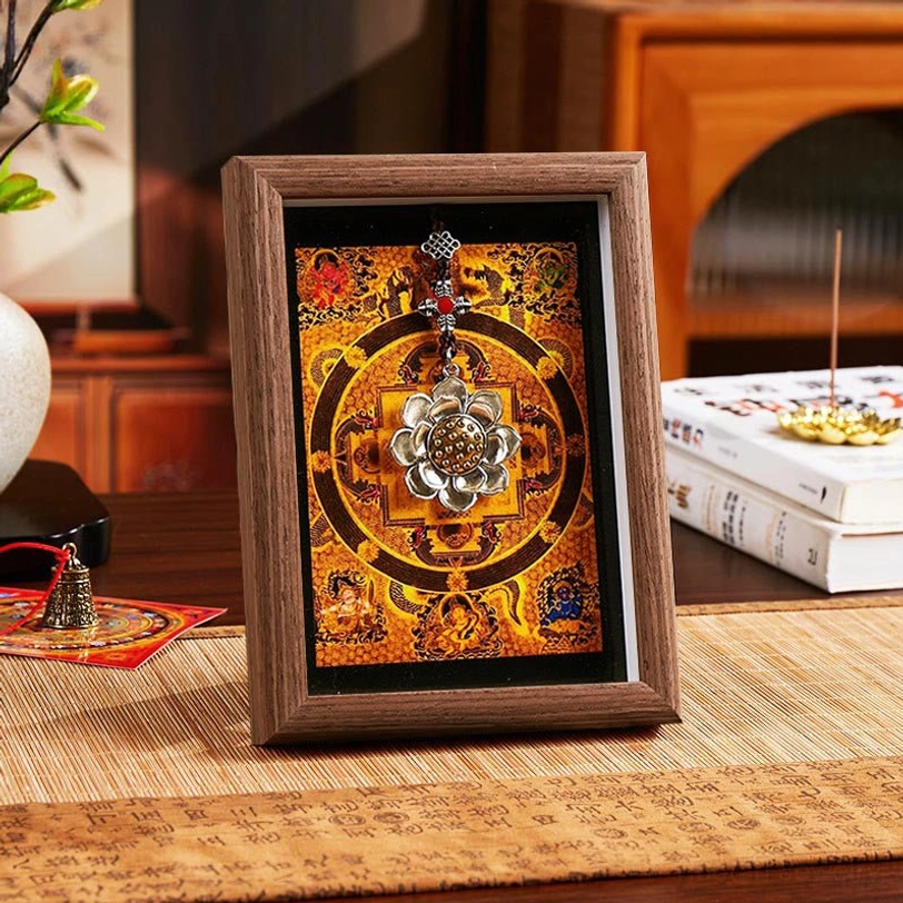 Tibetan lotus ingot thangka frame style 2 with dark brown wood frame and warm orange mandala artwork, featuring sacred silver lotus hanging decoration