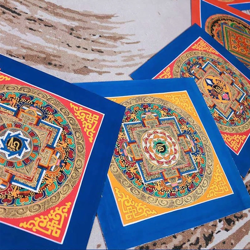 Tibetan handmade square mandala thangka with blue and red silk borders, featuring colorful gilt religious patterns and geometric designs