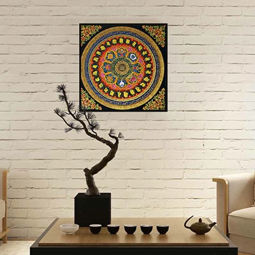 Tibetan Om Mani Padme Hum mandala thangka wall hanging with multicolored circular pattern displayed on white brick in modern living room