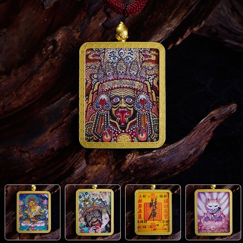 Collection of hand-painted Tibetan thangka deity pendants with gold frames on dark wood background - Zakiram, Nine-Tailed Fox, and wealth deity designs