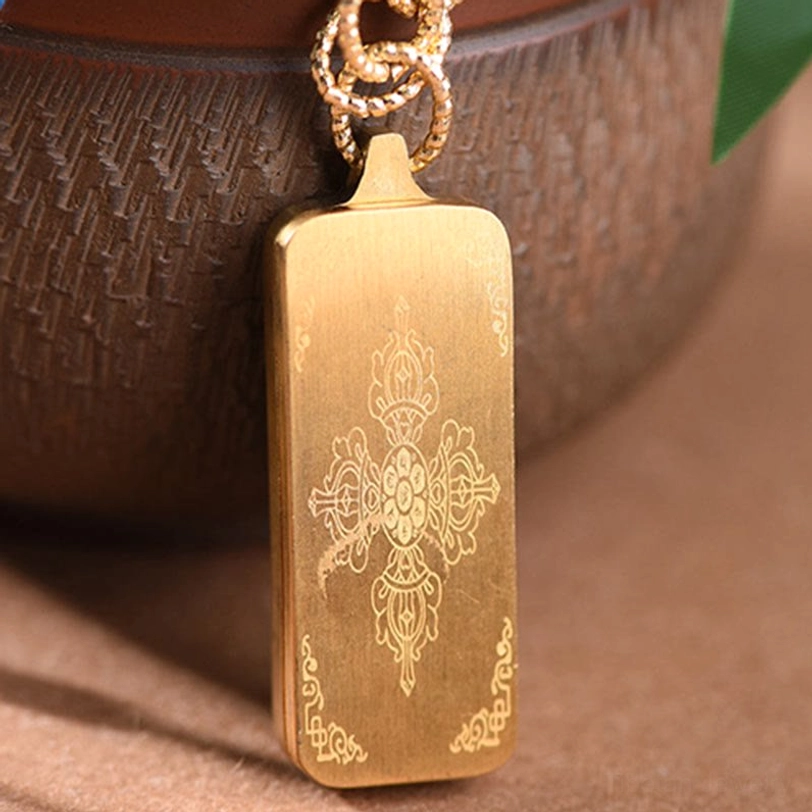 Gold titanium steel thangka pendant with engraved vajra Buddhist symbol side view