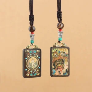 Two Tibetan thangka deity pendants displayed side-by-side showing different wealth god designs and styles