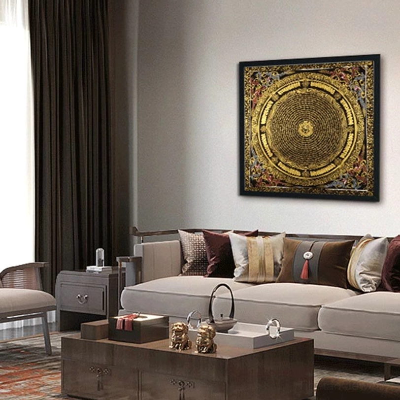 Wall-mounted Tibetan mandala thangka in modern living room, gold and black tones on light gray wall