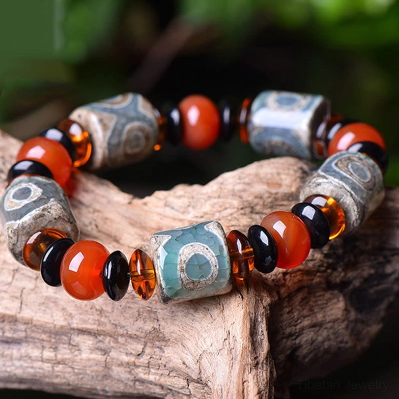 Handmade Tibetan Dzi Bead Agate Bracelet - three-quarter overhead view on weathered wood showing complete circular bead arrangement and individual bead details