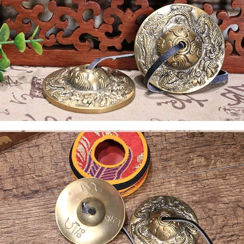 Tibetan sound healing tingsha bells on wooden surface with Buddhist spiritual decor background