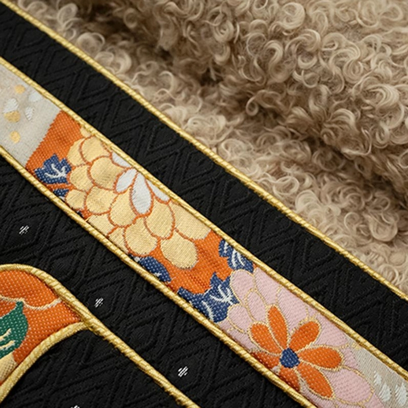 Close-up detail of Tibetan top ethnic ribbon trim with gold braided edging and curly fleece lining