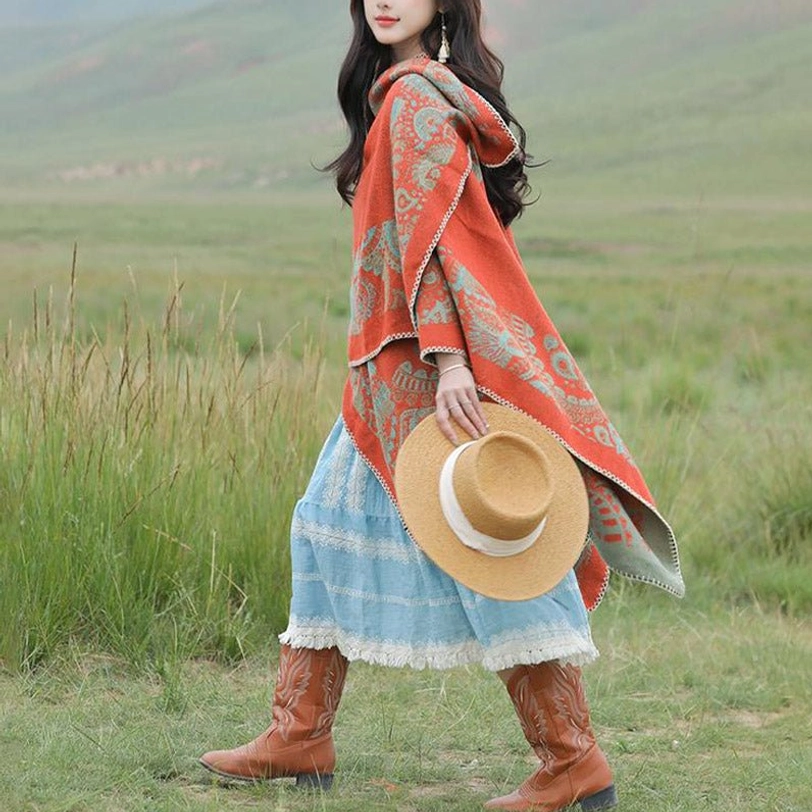 Tibetan travel poncho wrap worn while walking, holding straw hat, soft warm texture visible on grassland