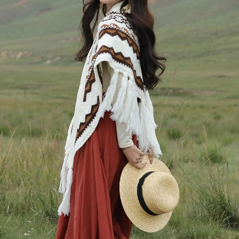 Rear side view of tasseled Tibetan triangle shawl showing ethnic geometric pattern and warm knit texture