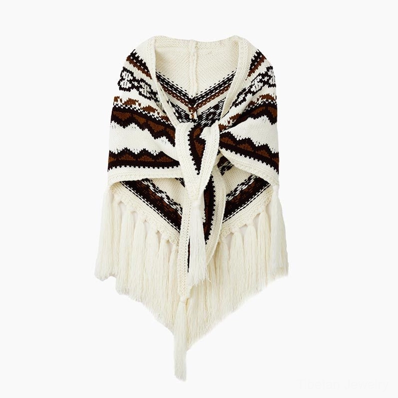 Tibetan triangular shawl with hand-tied tassels on grassland showcasing traditional craftsmanship