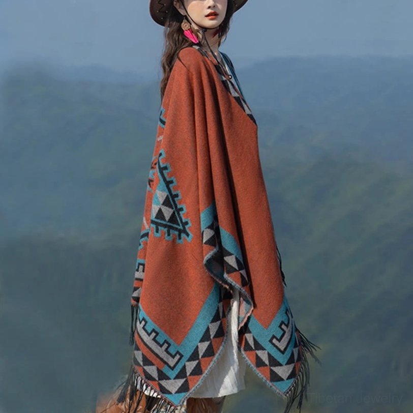 Left side full view of tribal tassel shawl poncho showing lower hem with triangle geometric patterns and authentic tassel fringe