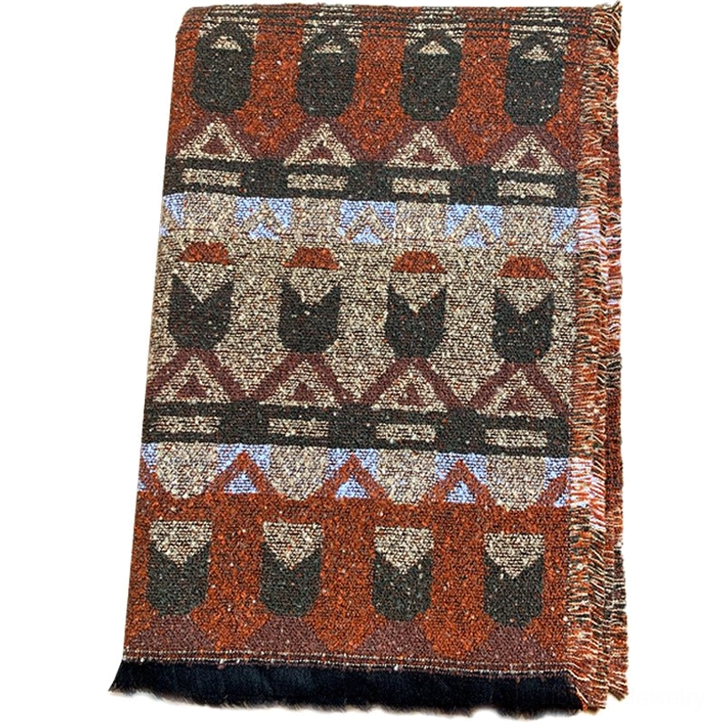 Flat lay Tibetan ethnic woven scarf showing repeating geometric tribal motifs, frayed edges and multi-color woven design on studio background