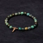Tibetan turquoise copper spike balance bracelet flat lay - handmade beaded design with copper charm