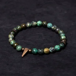 Tibetan turquoise copper spike balance bracelet flat lay - handmade beaded design with copper charm