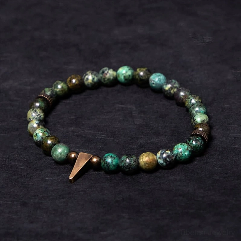 Tibetan turquoise copper spike balance bracelet flat lay - handmade beaded design with copper charm