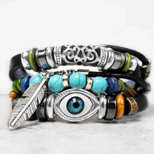 Tibetan turquoise evil eye leather bracelet front view with layered straps feather charm and filigree accents